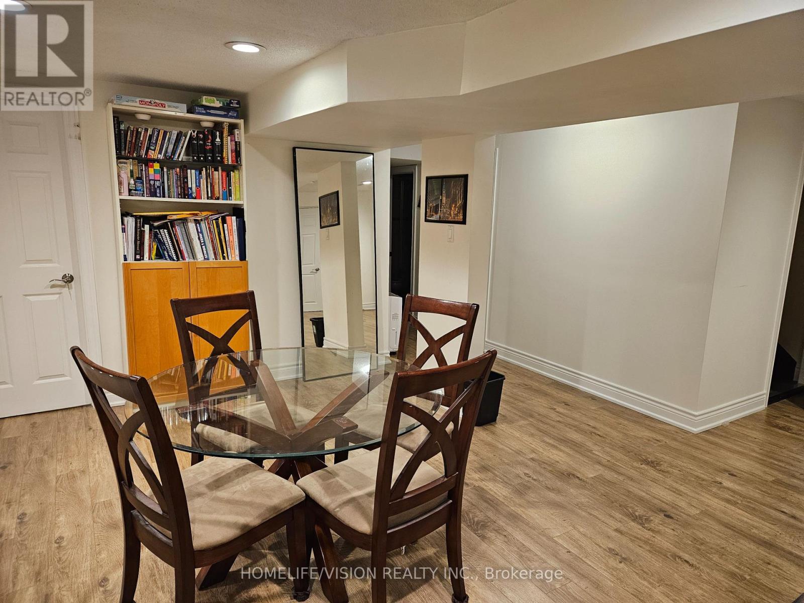 A dining room with a glass table and chairs.