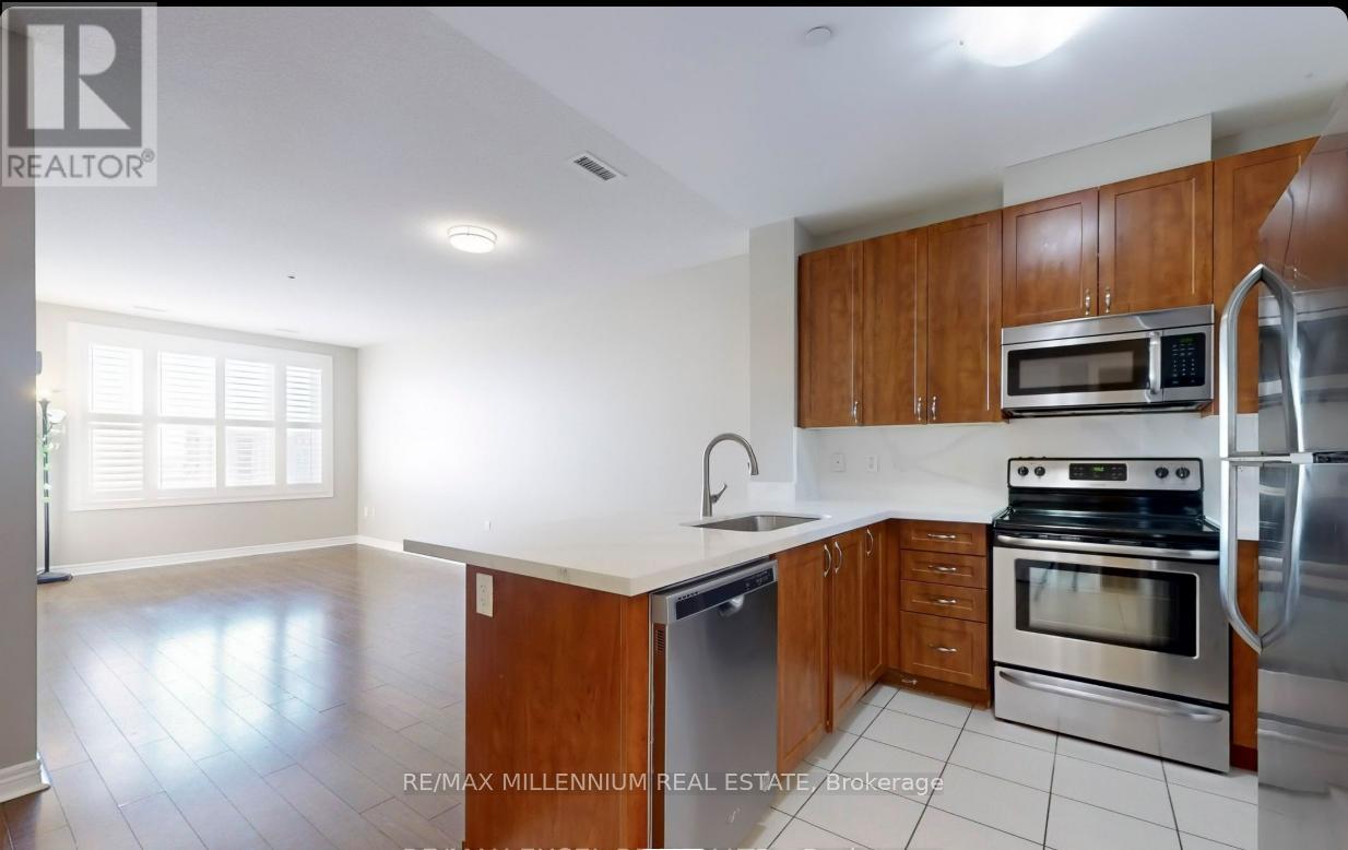 A kitchen with wooden cabinets and stainless steel appliances.