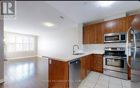 A kitchen with wooden cabinets and stainless steel appliances.