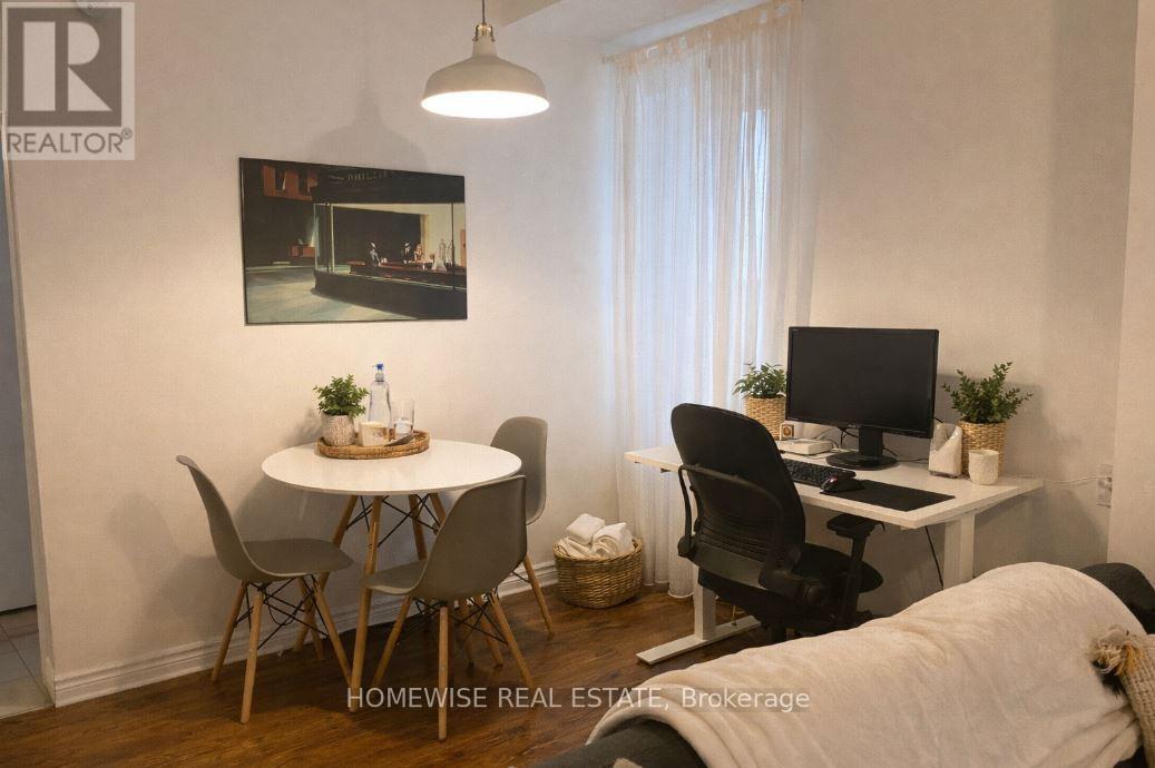 A home office with a desk, chair, and a poster on the wall.