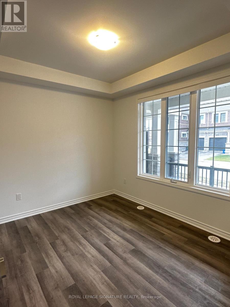 A room with a window and wooden flooring.