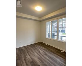 A room with a window and wooden flooring.