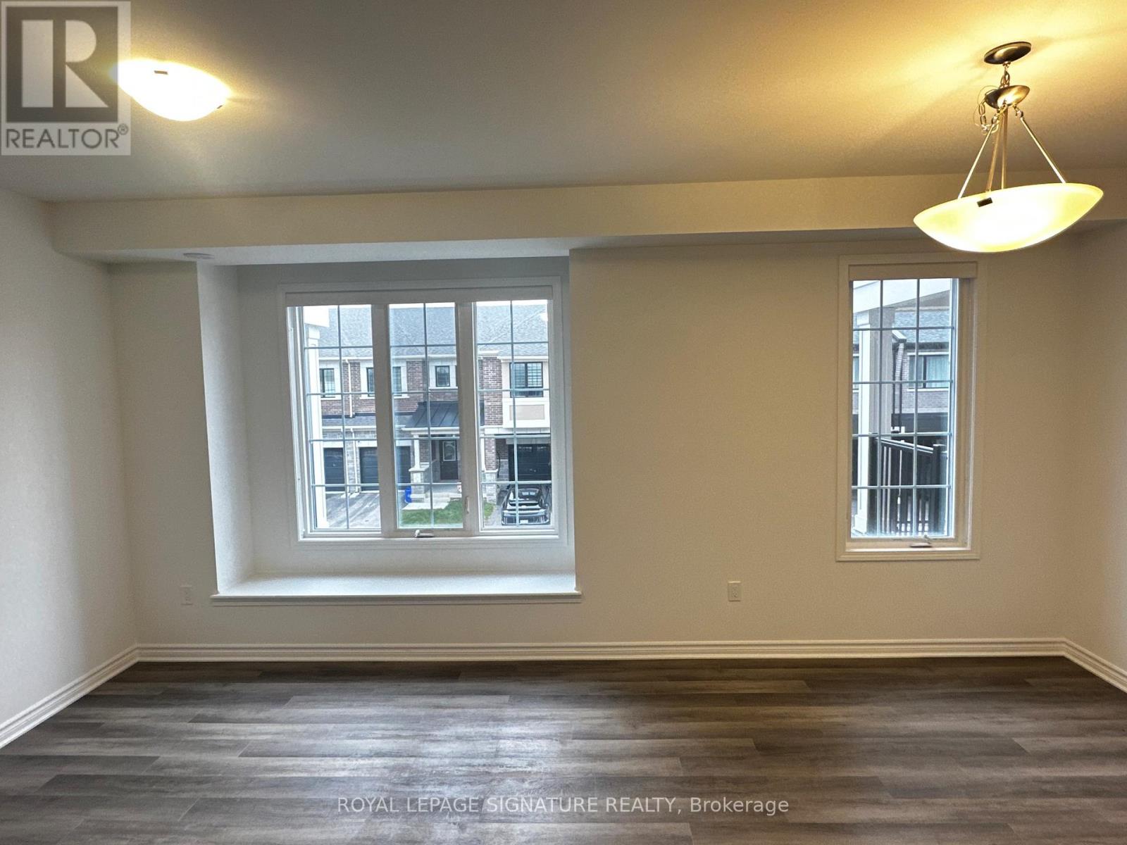 A room with a large window and a smaller window on the wall.