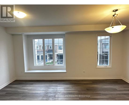 A room with a large window and a smaller window on the wall.