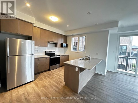 A kitchen with a refrigerator, stove, and countertops.