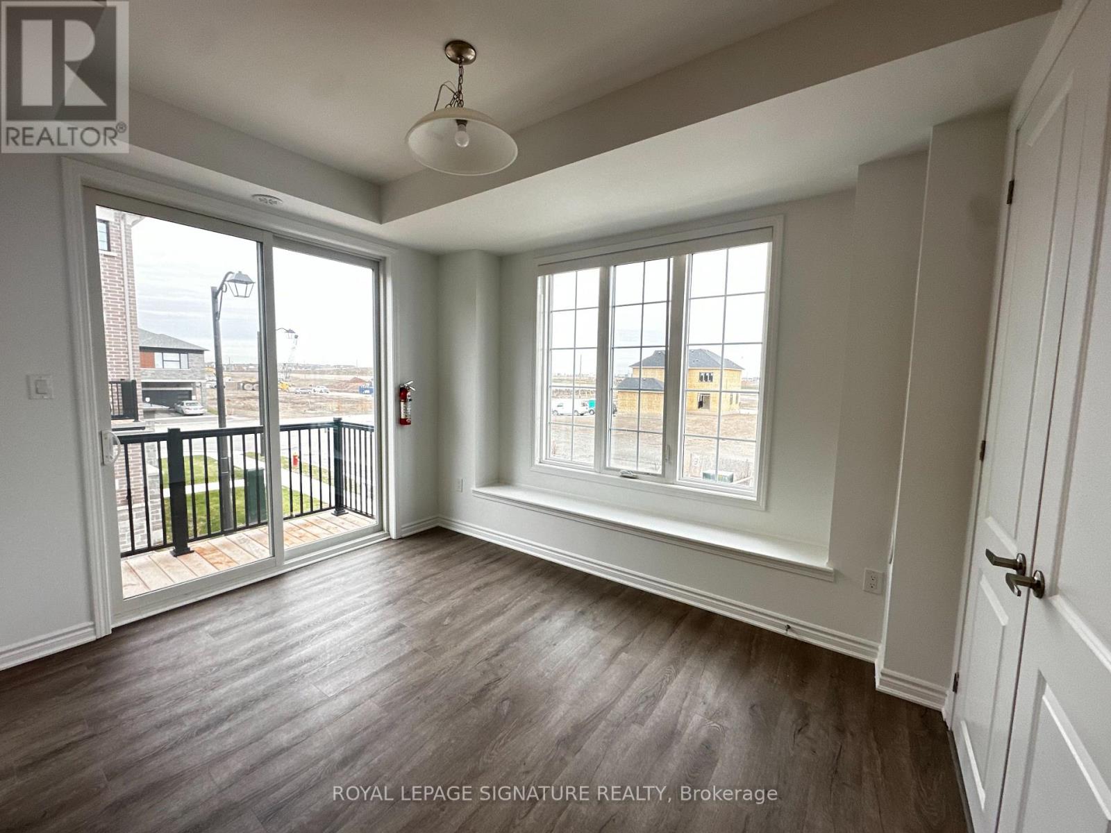 A room with a sliding glass door leading to a balcony.