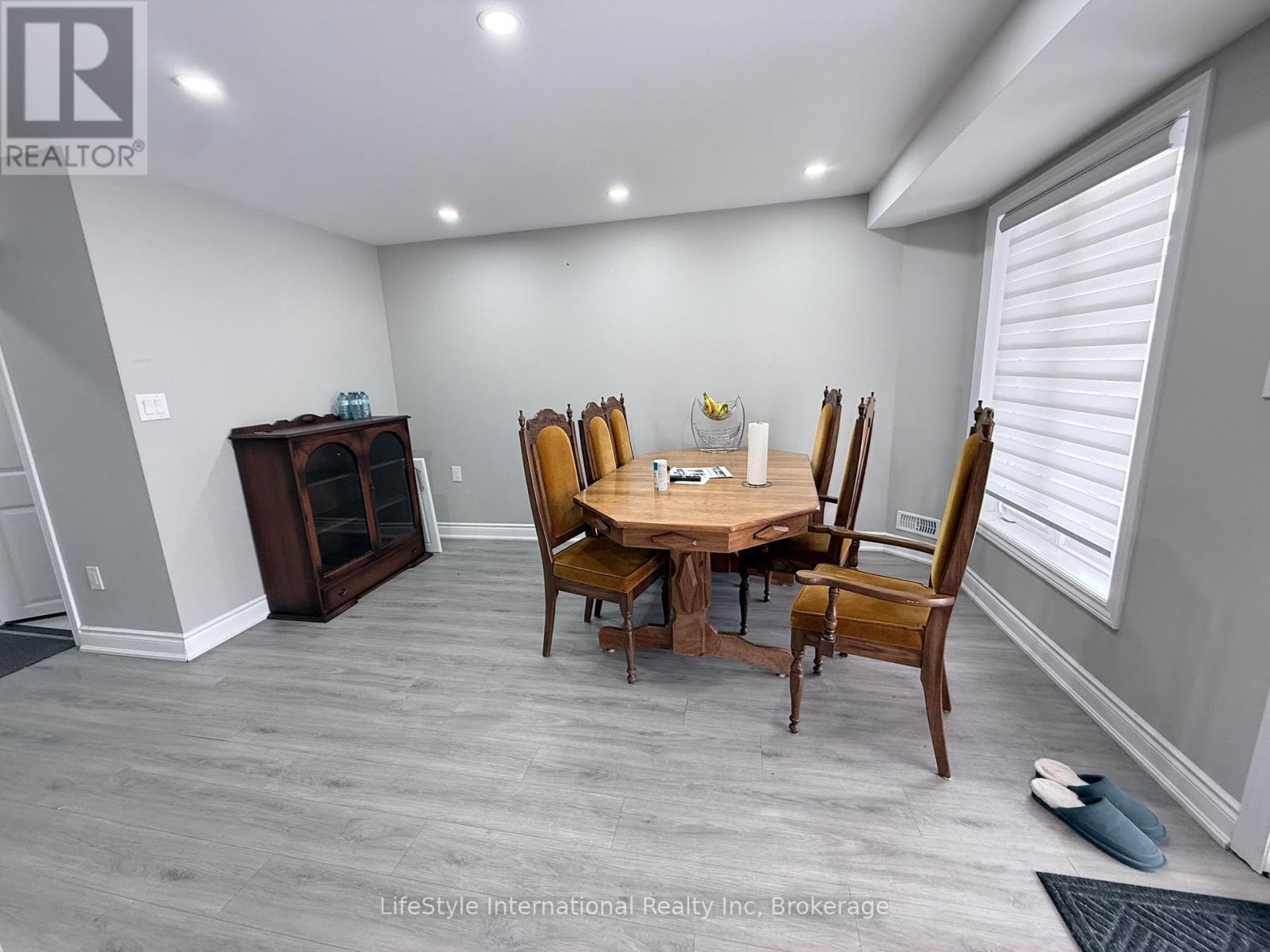 A dining room with a wooden table and chairs.