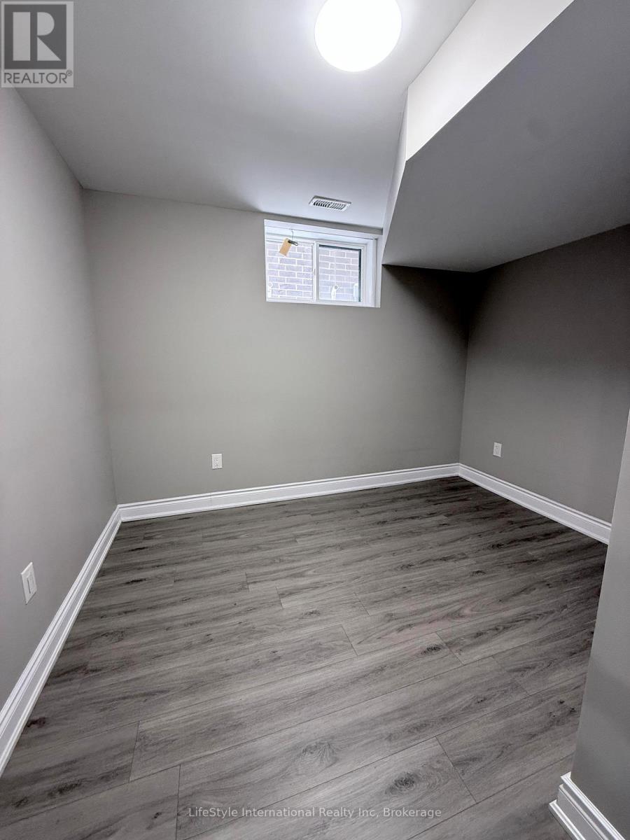 A room with wooden flooring and a white ceiling.
