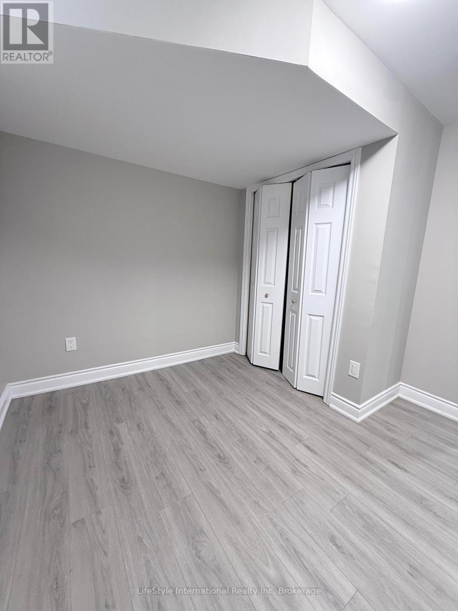 A room with a white door and grey walls.
