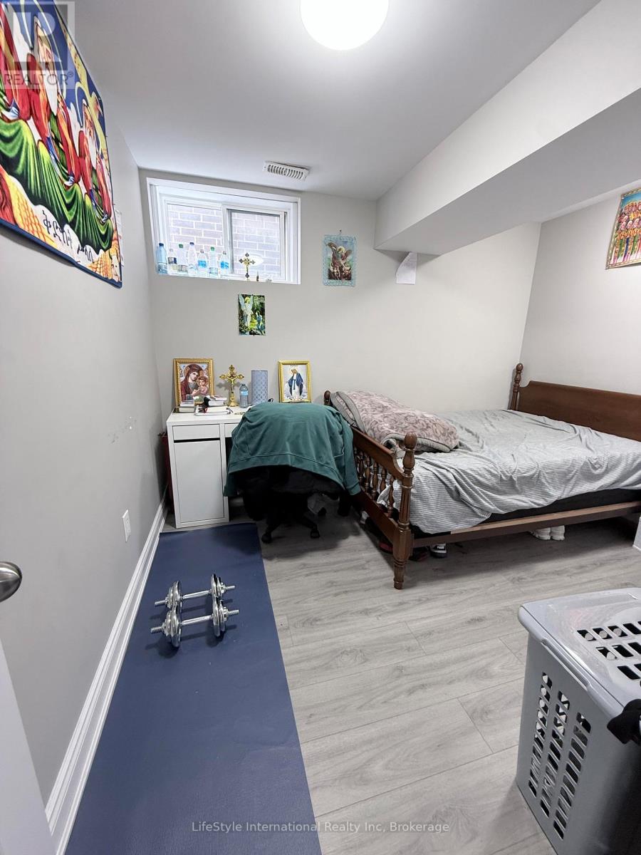 A bedroom with a bed, a dresser, and a window.