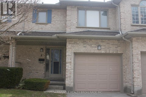 A house with a brown garage door is for sale.