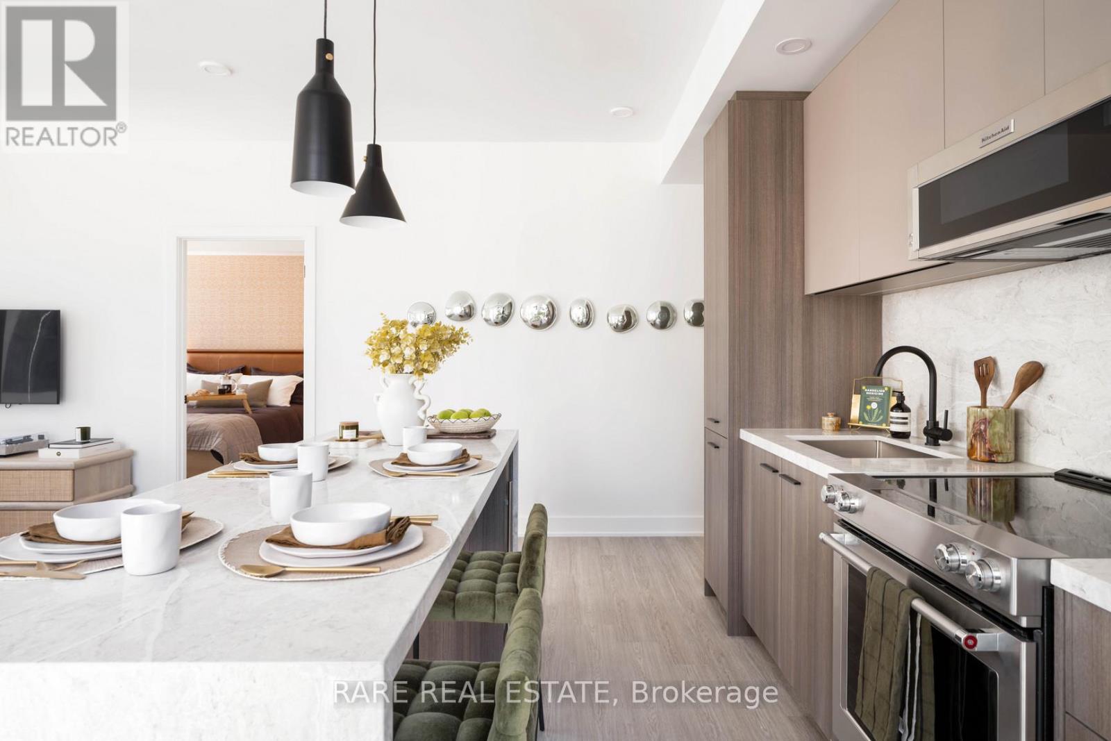 A modern kitchen with a dining table set for four.