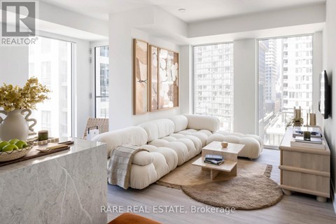 A living room with a large white sofa and a coffee table.