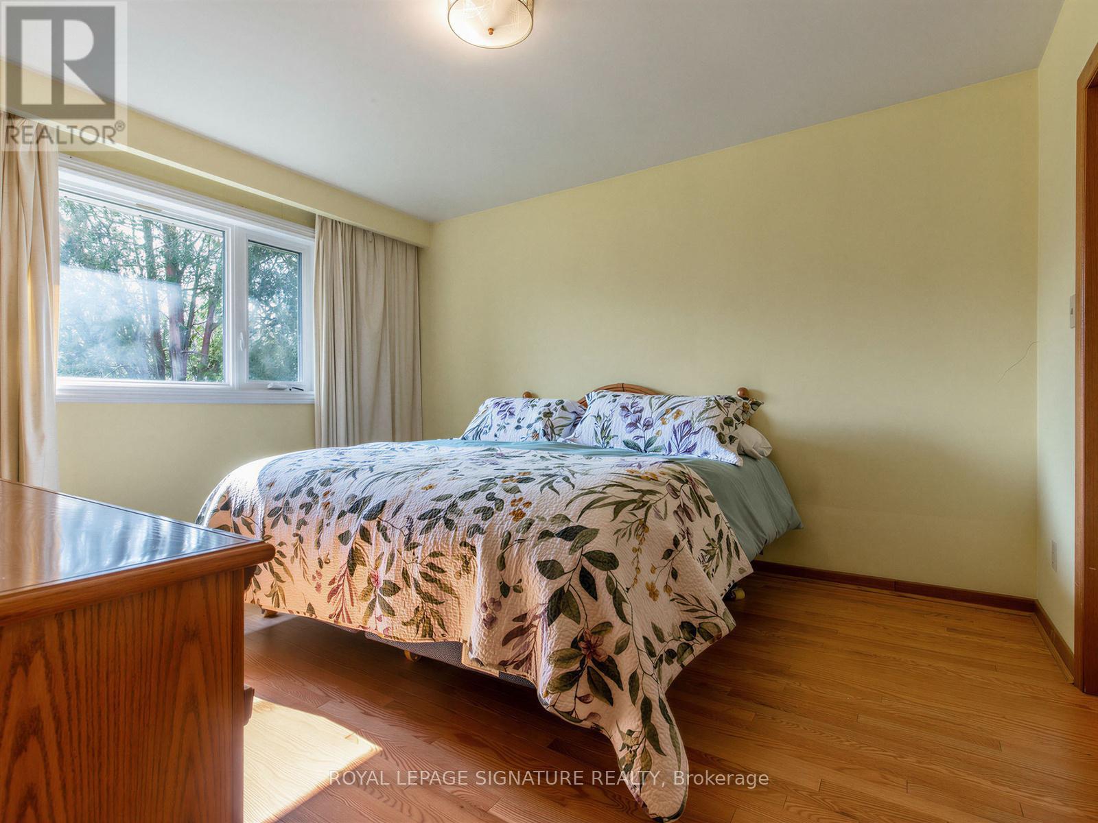 A bedroom with a bed and a window.