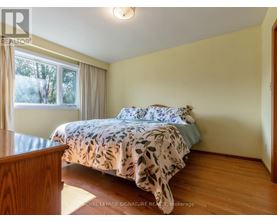 A bedroom with a bed and a window.