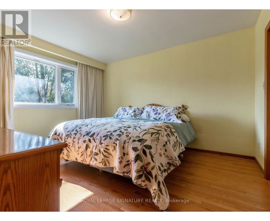 A bedroom with a bed and a window.