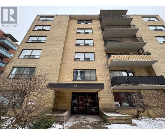 A tall apartment building with the number 51 on the front.