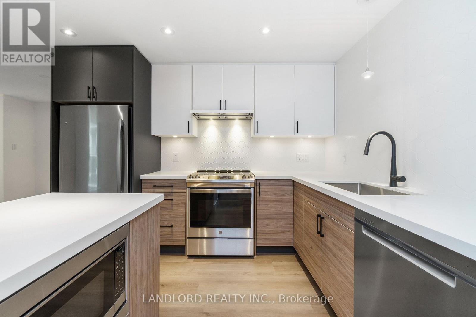 A modern kitchen with wooden cabinets and stainless steel appliances.