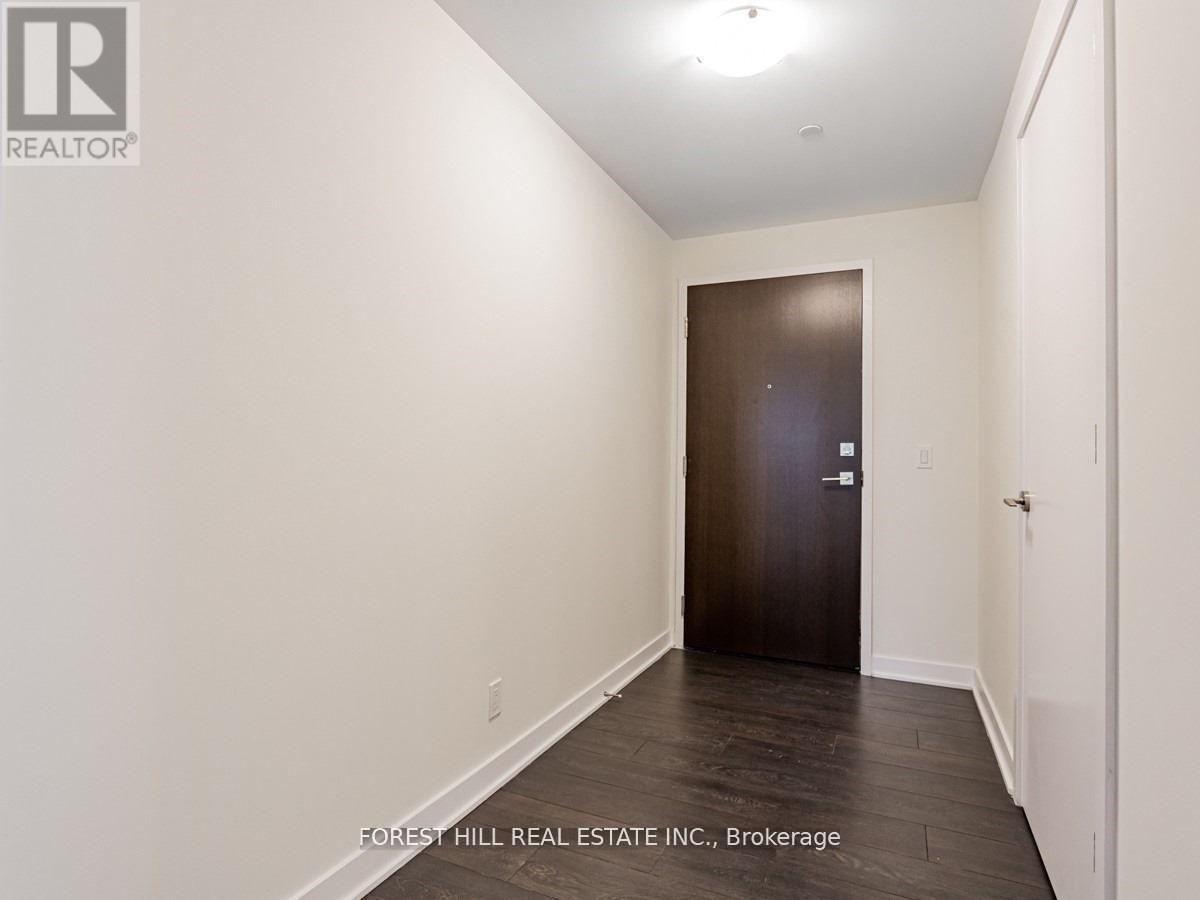 A hallway with a door at the end.