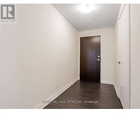 A hallway with a door at the end.