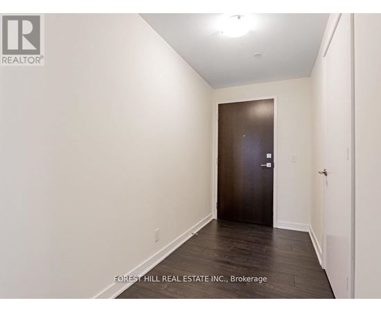 A hallway with a door at the end.