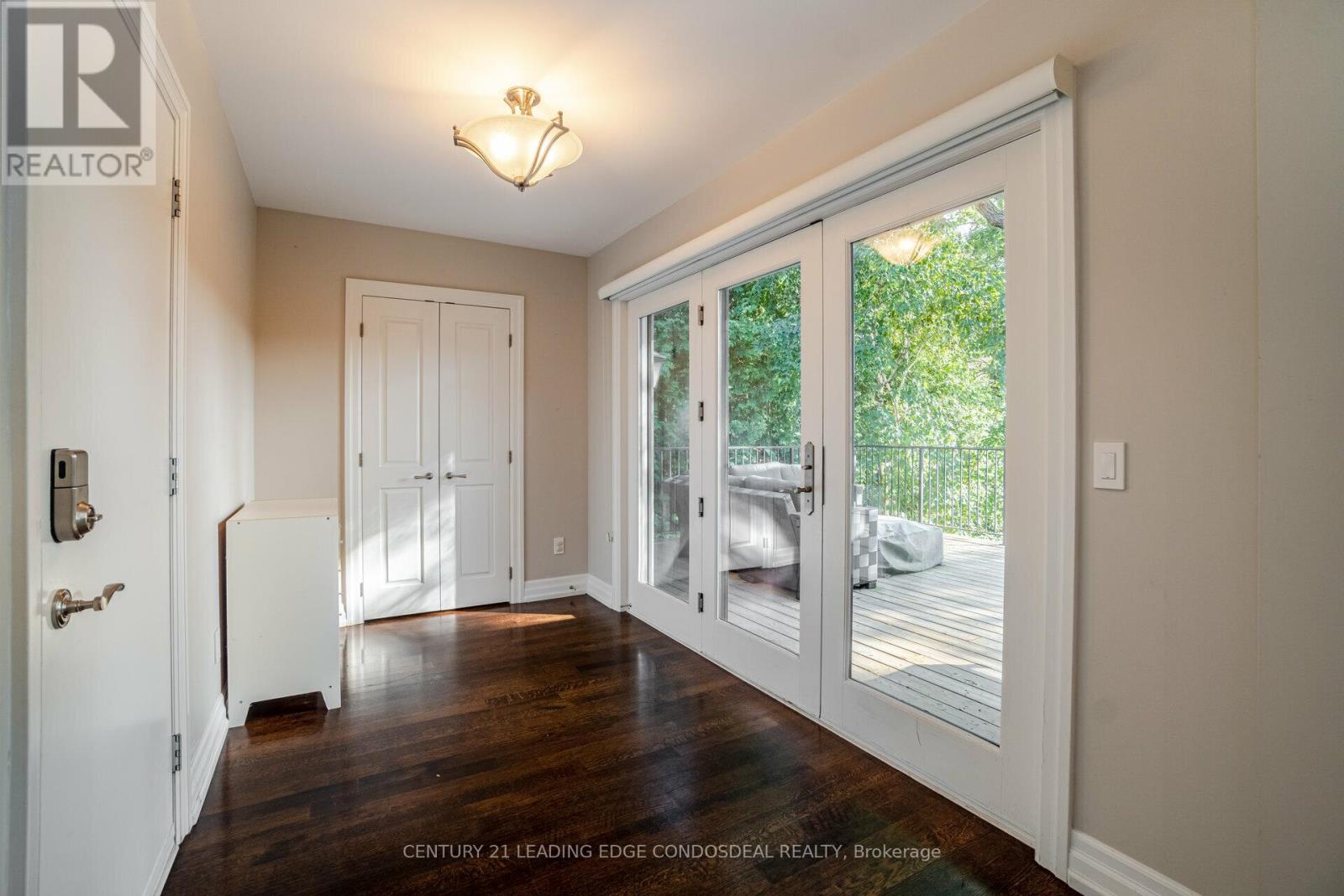 A real estate listing photo of a bedroom with a sliding glass door.