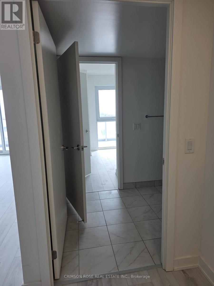 A hallway with a door open to a bedroom.