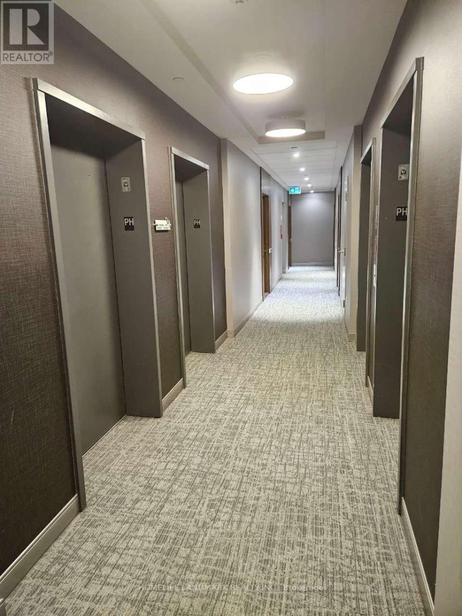 A hallway with elevators on the left and right.