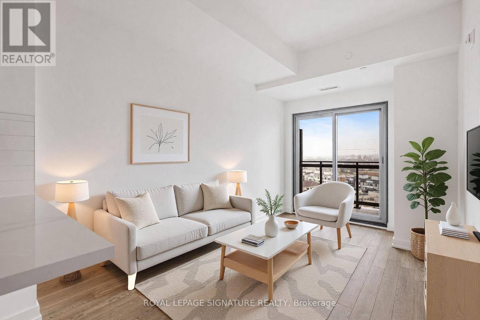 A well-lit living room with a large window and a view of the city.