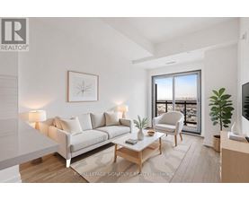 A well-lit living room with a large window and a view of the city.