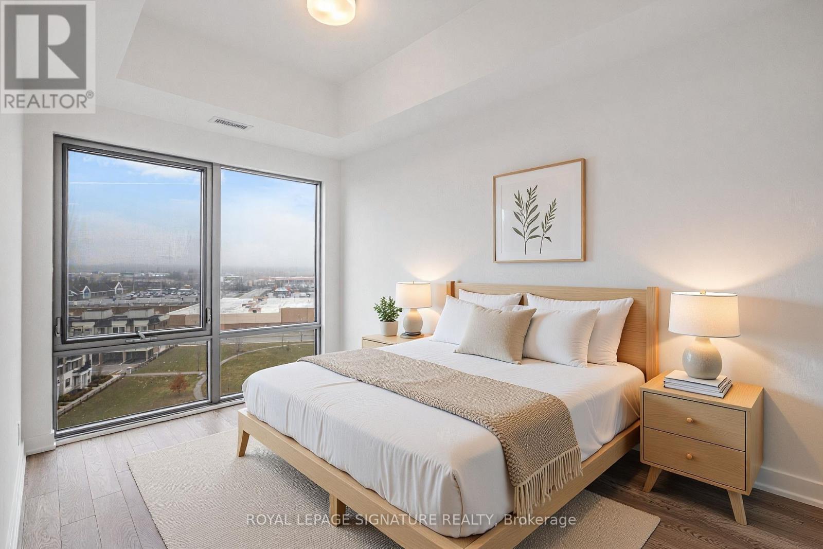 A bedroom with a large bed and a view of the city.