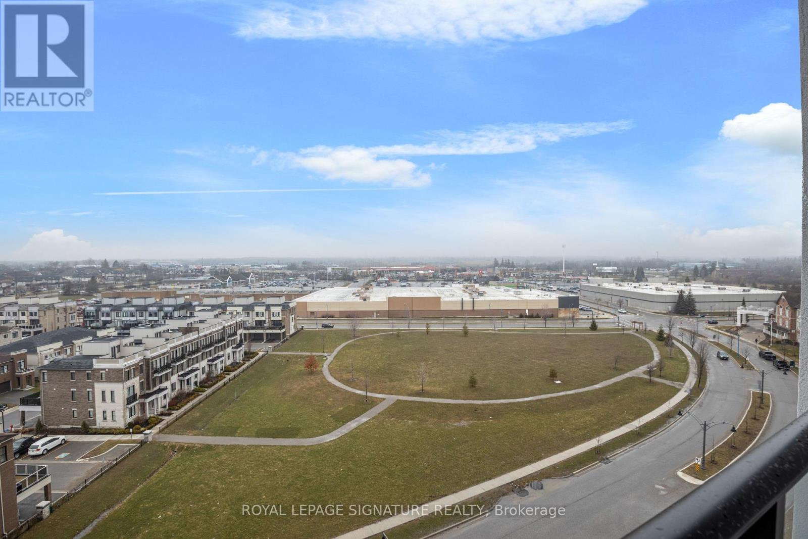 A view of a city from a high vantage point with a large building in the center.