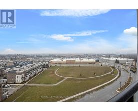 A view of a city from a high vantage point with a large building in the center.
