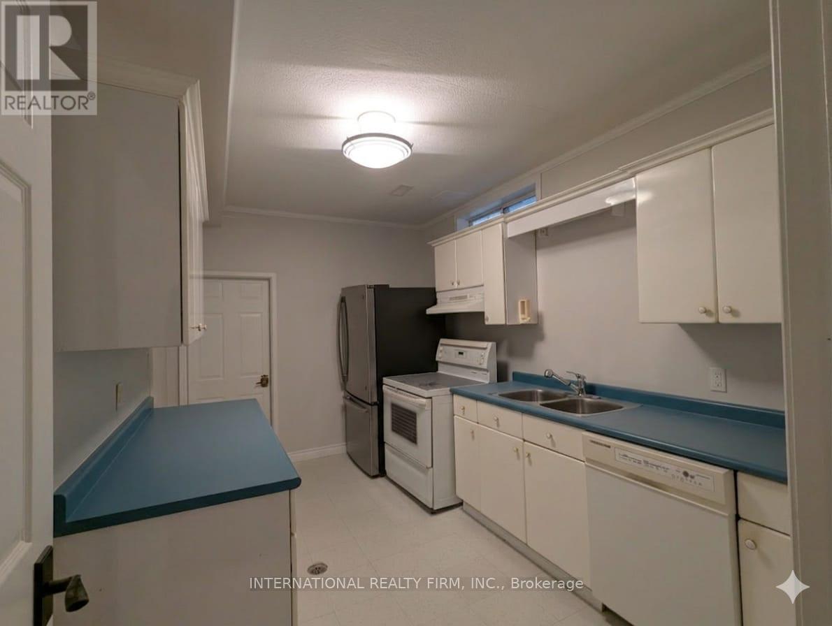 A kitchen with white cabinets and a blue countertop.