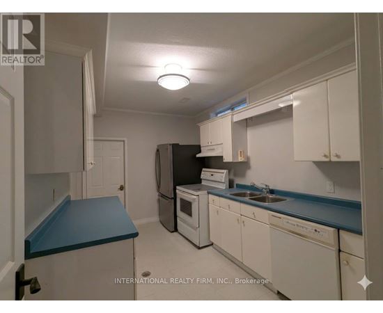 A kitchen with white cabinets and a blue countertop.