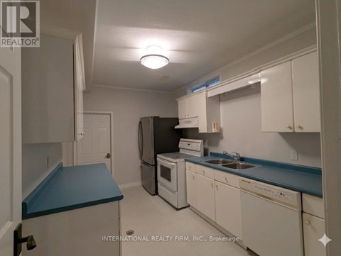 A kitchen with white cabinets and a blue countertop.