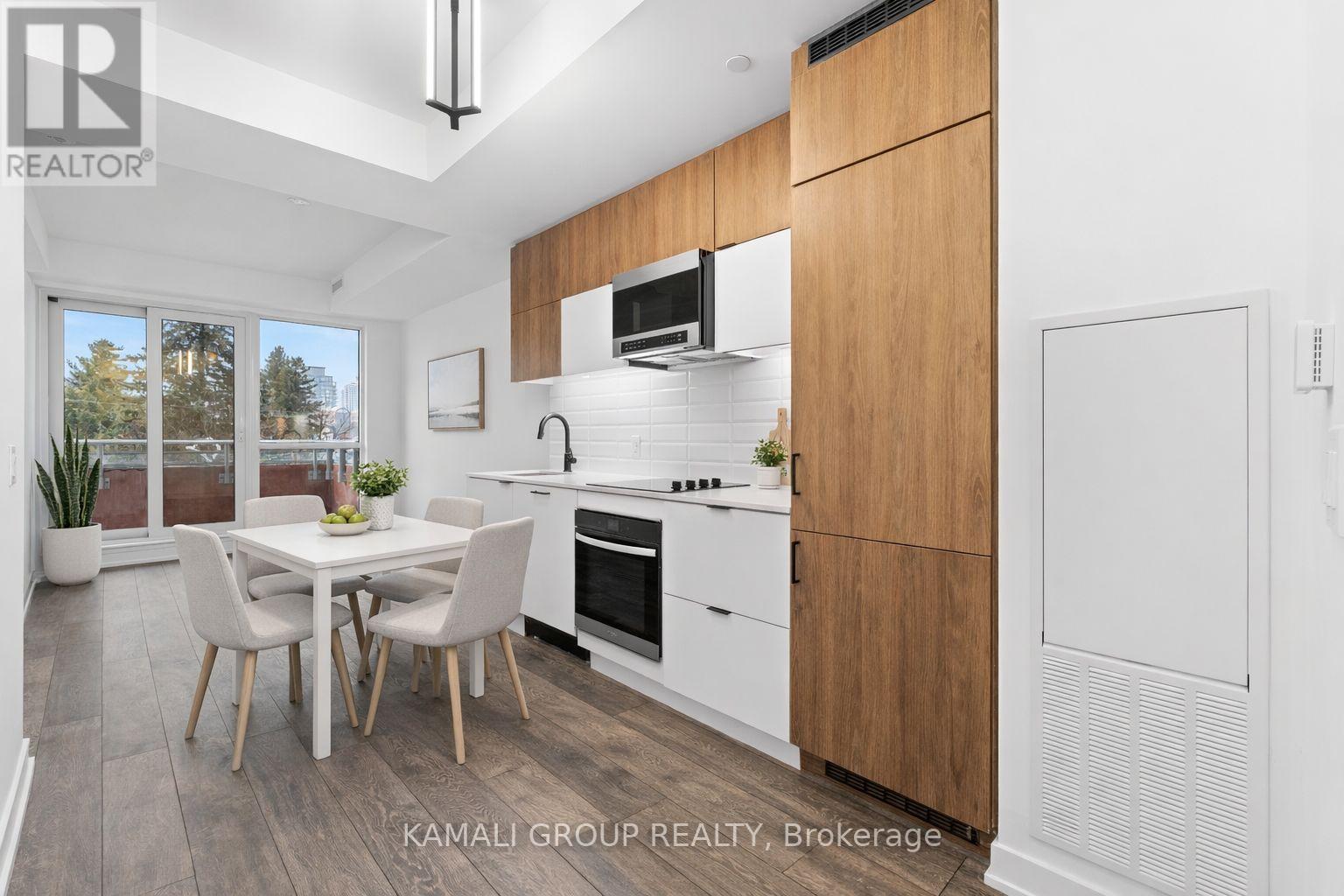 A modern kitchen with a dining table and chairs.