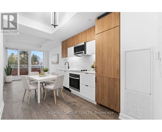 A modern kitchen with a dining table and chairs.