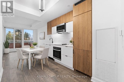 A modern kitchen with a dining table and chairs.