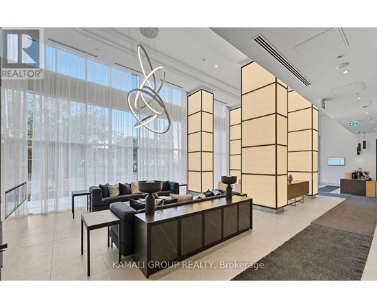 A modern office space with a reception desk and a large window with curtains.