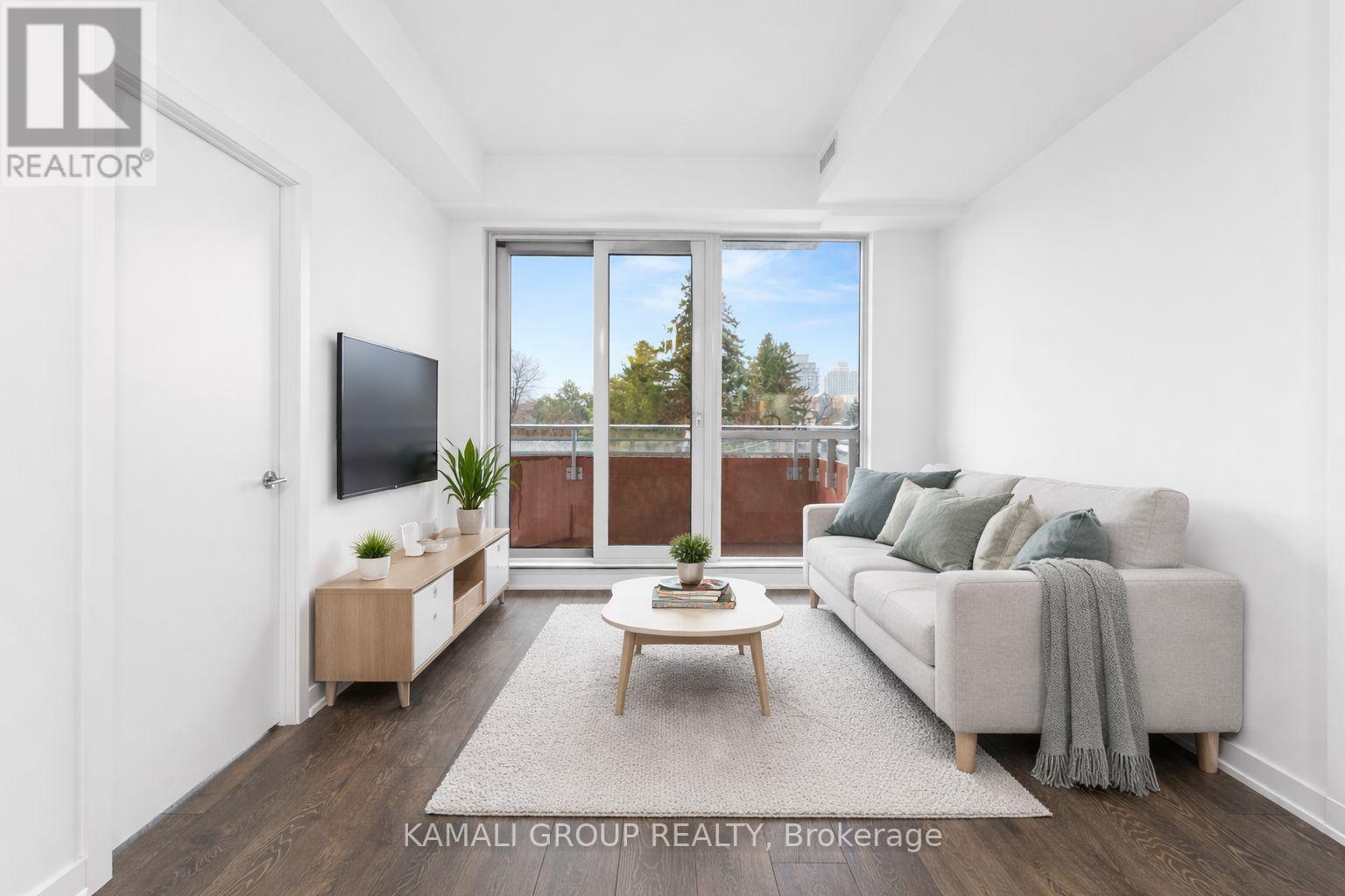 A living room with a couch, a television, and a coffee table.