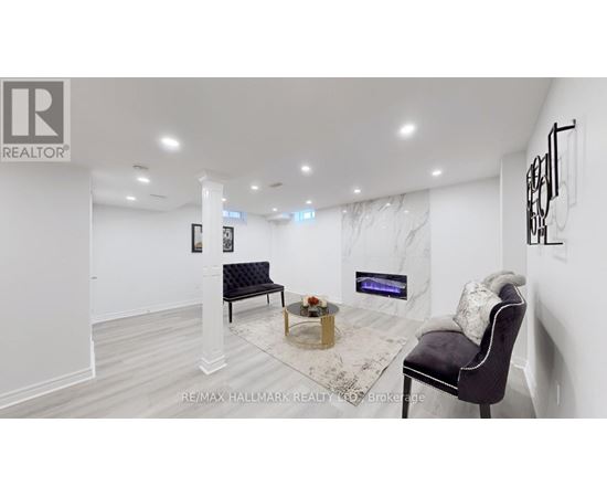 A living room with a black chair and a coffee table.