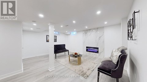 A living room with a black chair and a coffee table.