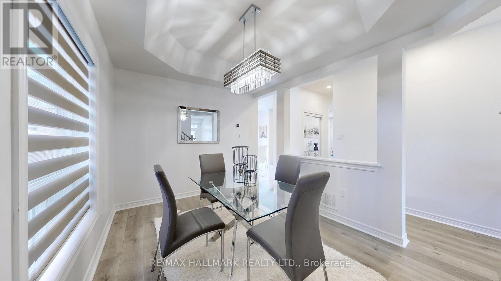 A dining room with a glass table and chairs.