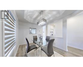 A dining room with a glass table and chairs.