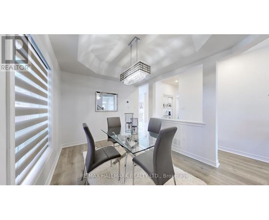 A dining room with a glass table and chairs.
