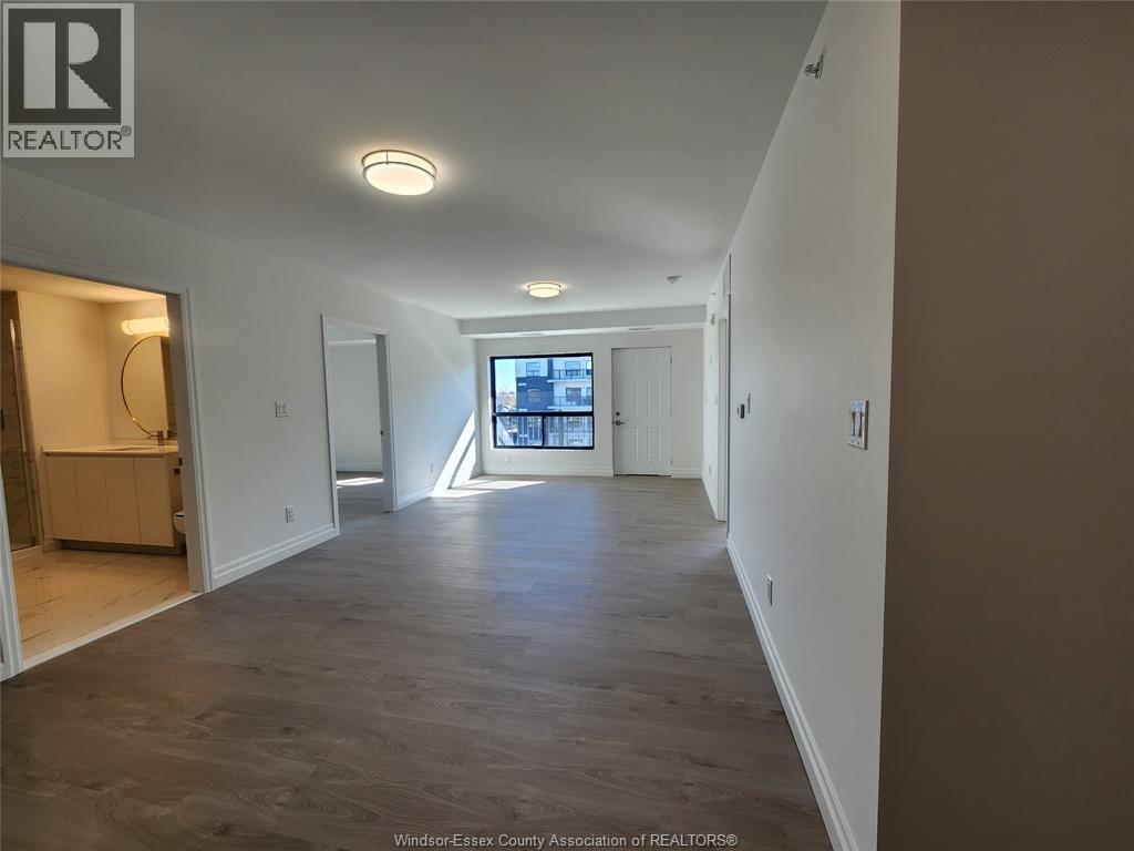 A spacious room with a large window and a view of the city.