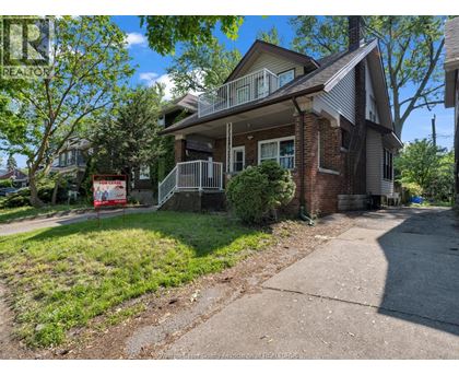 A house with a red sign in front of it.