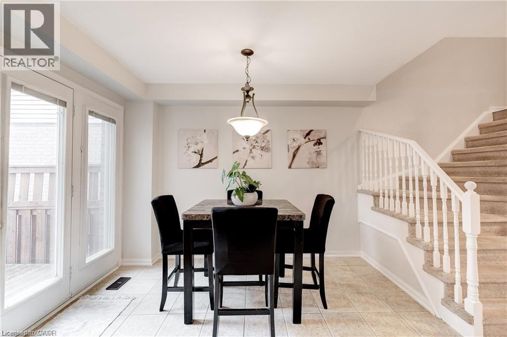 A dining room with a table set for four.