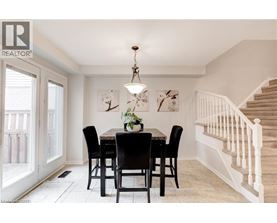 A dining room with a table set for four.